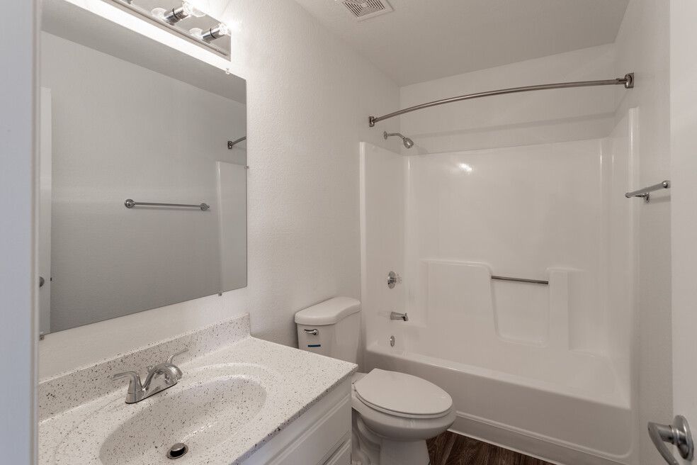 A bathroom with a toilet , sink , and bathtub.