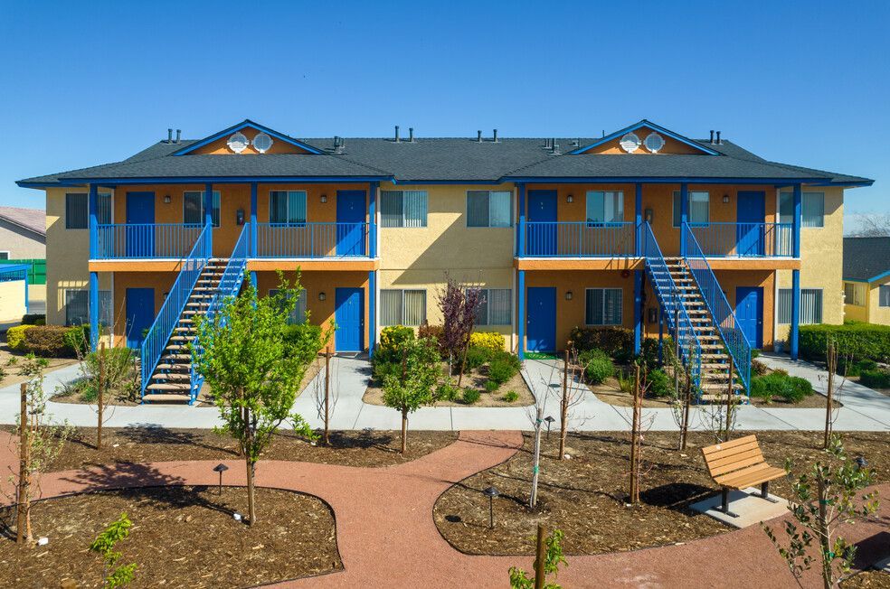 A large apartment building with blue doors and stairs