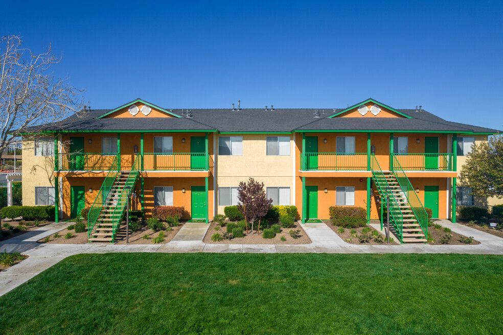 A large apartment building with orange and green walls and stairs.