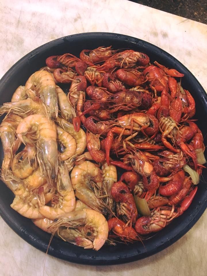 A plate of shrimp and crawfish on a table.