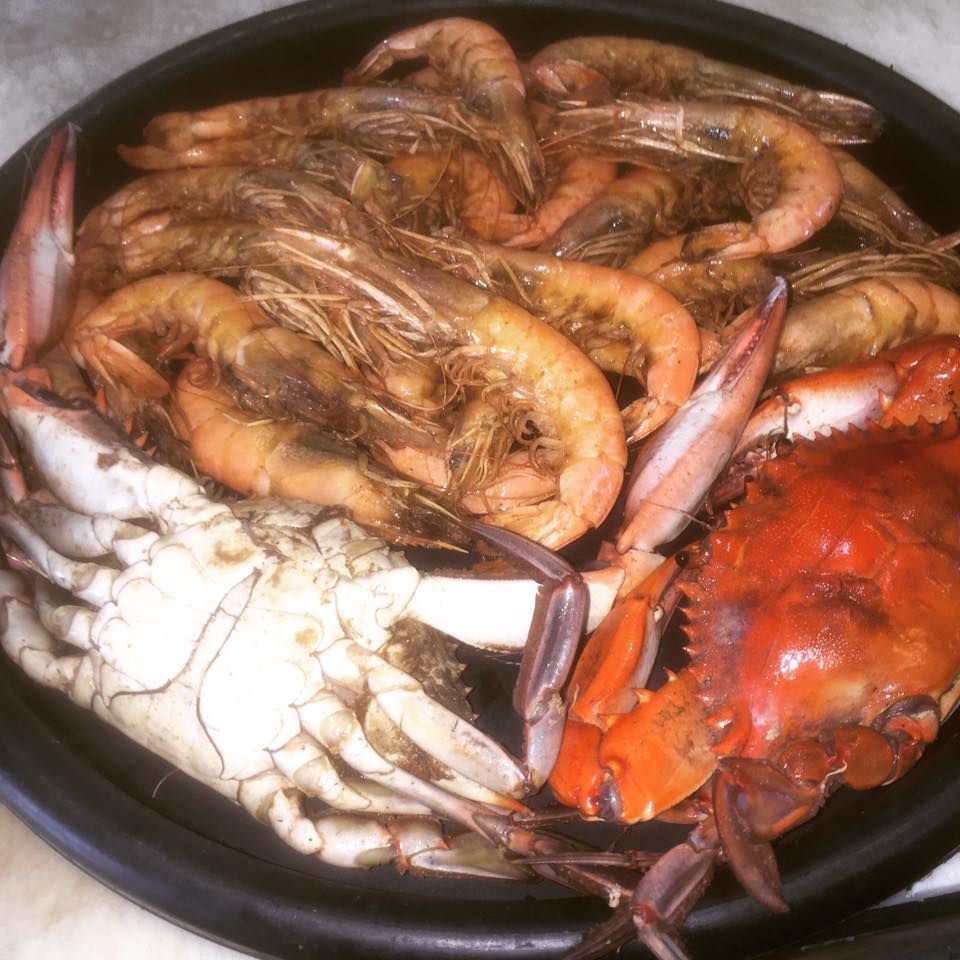 A plate of shrimp and crabs on a table