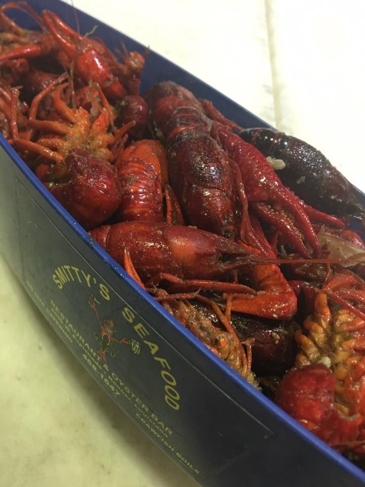 A blue container filled with crayfish says pretty 's seafood