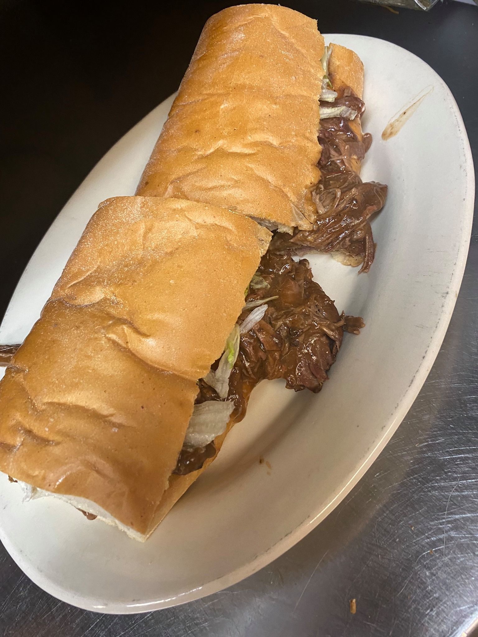 A lot of cars are parked in front of a building.