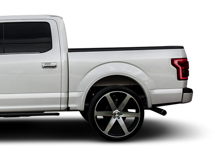 White pickup truck with oversized black and silver wheels, custom fender flares, and a white background | NOR-CAL AUTOMOTIVE