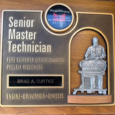 Plaque for Brad A. Curtice, Ford Senior Master Technician. Bronze-colored with a technician figurine.