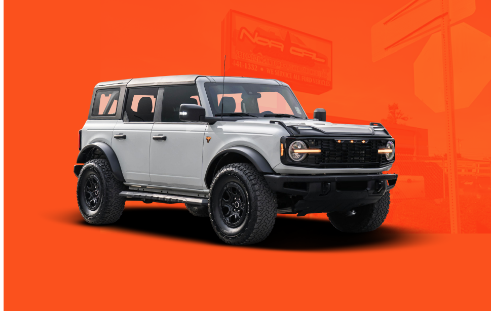 White Ford Bronco SUV on an orange background, black wheels and front grill | NOR-CAL AUTOMOTIVE