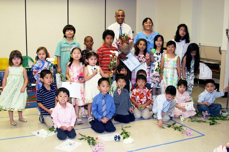 A group of children are posing for a picture in a room.