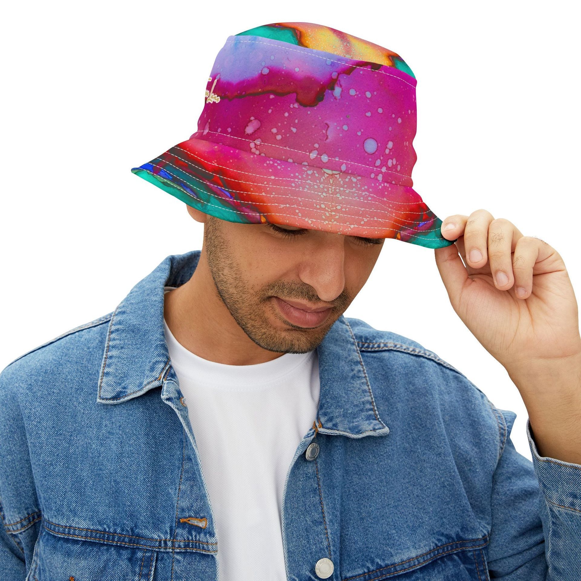 Man wearing a colorful, abstract-patterned bucket hat, looking down. He's wearing a denim jacket over a white t-shirt.