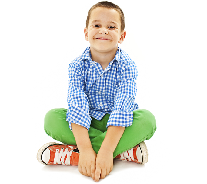 young 5 year old boy sitting with legs crossed smiling