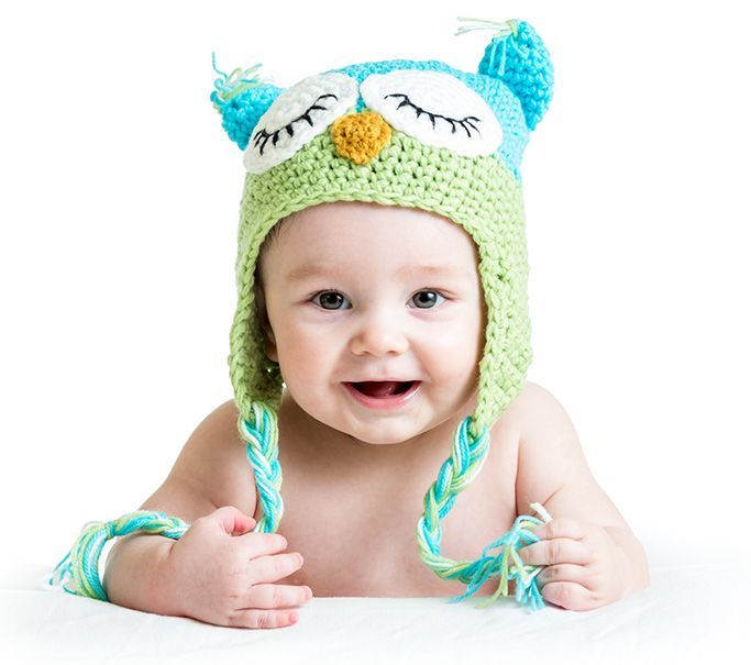 cute young baby boy wearing a knitted owl hat
