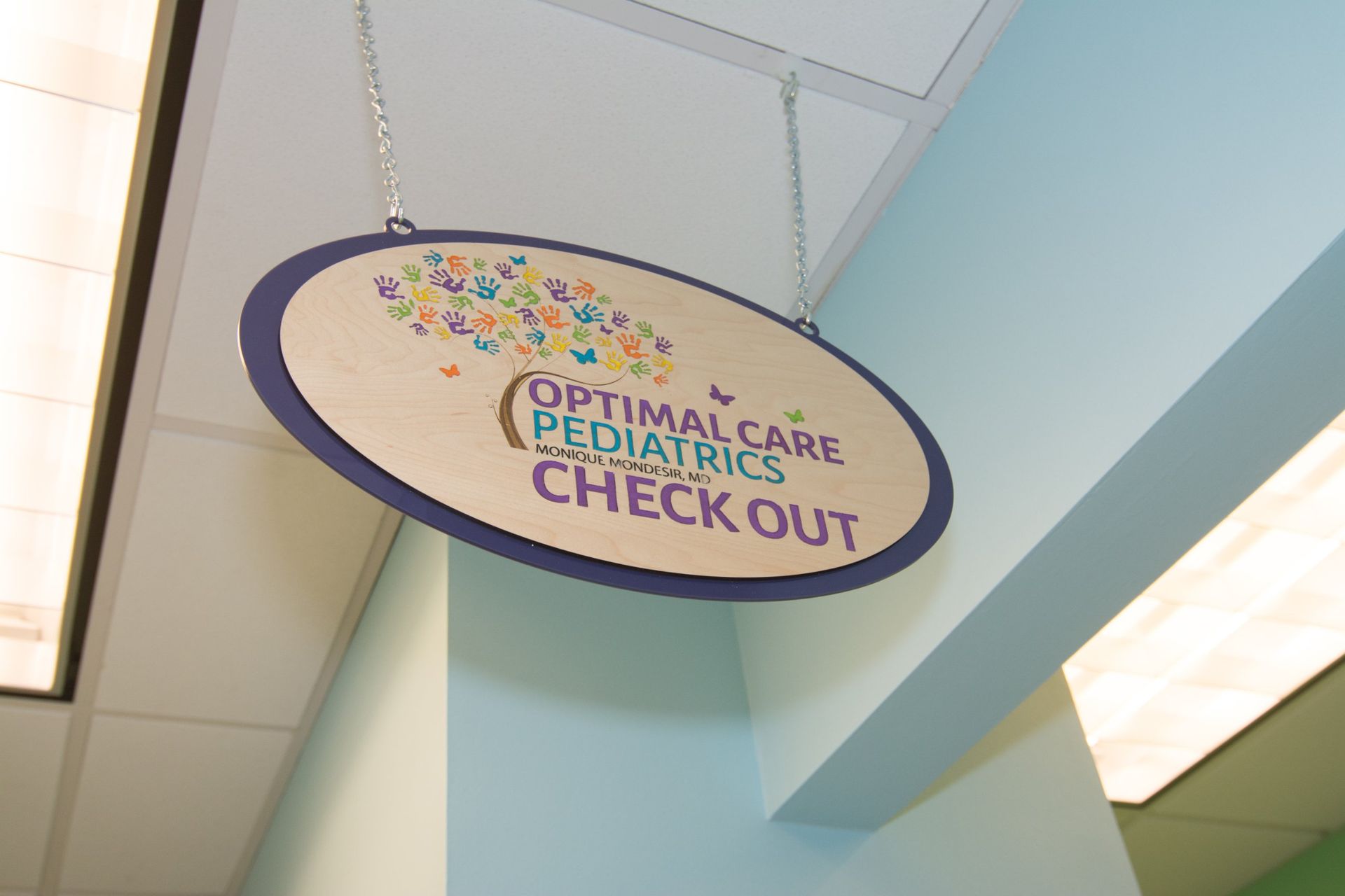 Check out sign hanging from the ceiling beside the light with the Optimal Care Pediatrics Logo