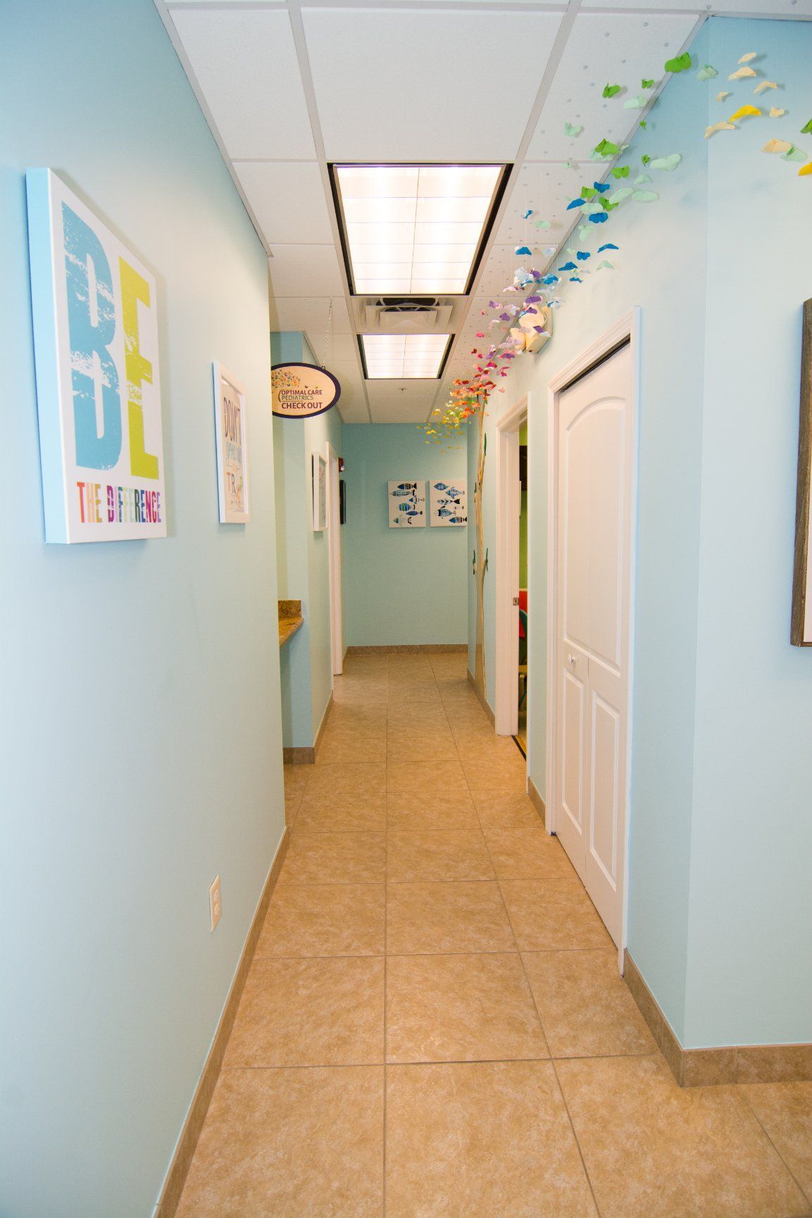 Photo of the office's hallway showing white doors of consultation rooms