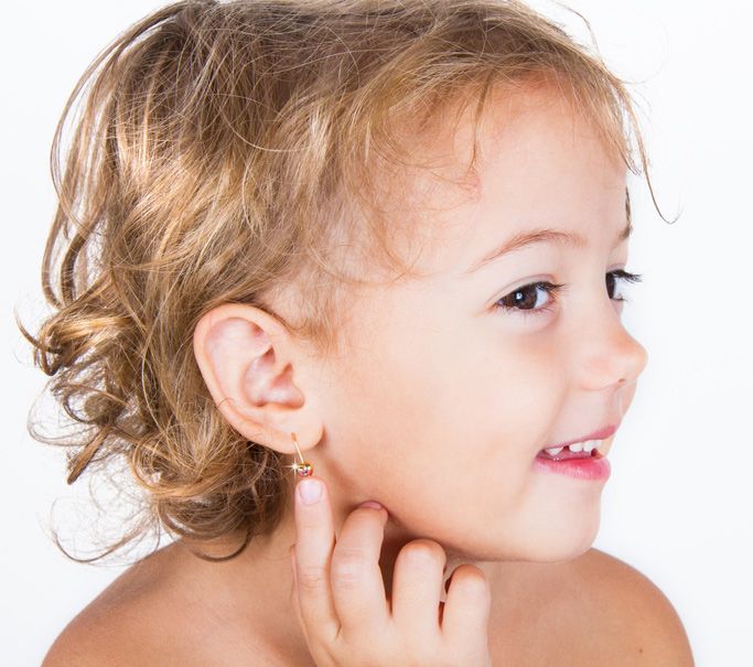 young child with ears pierced
