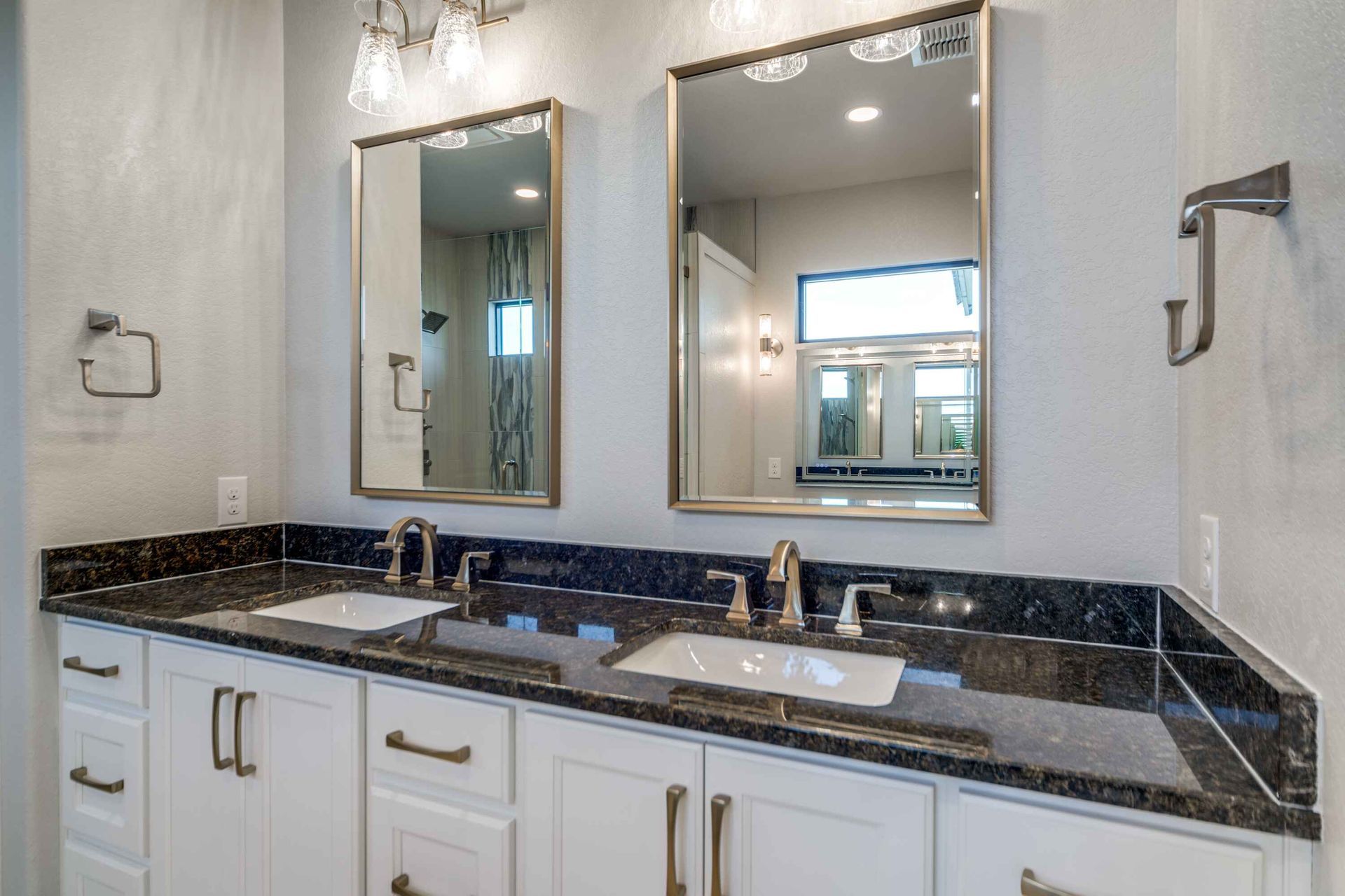 A bathroom with two sinks and two mirrors.