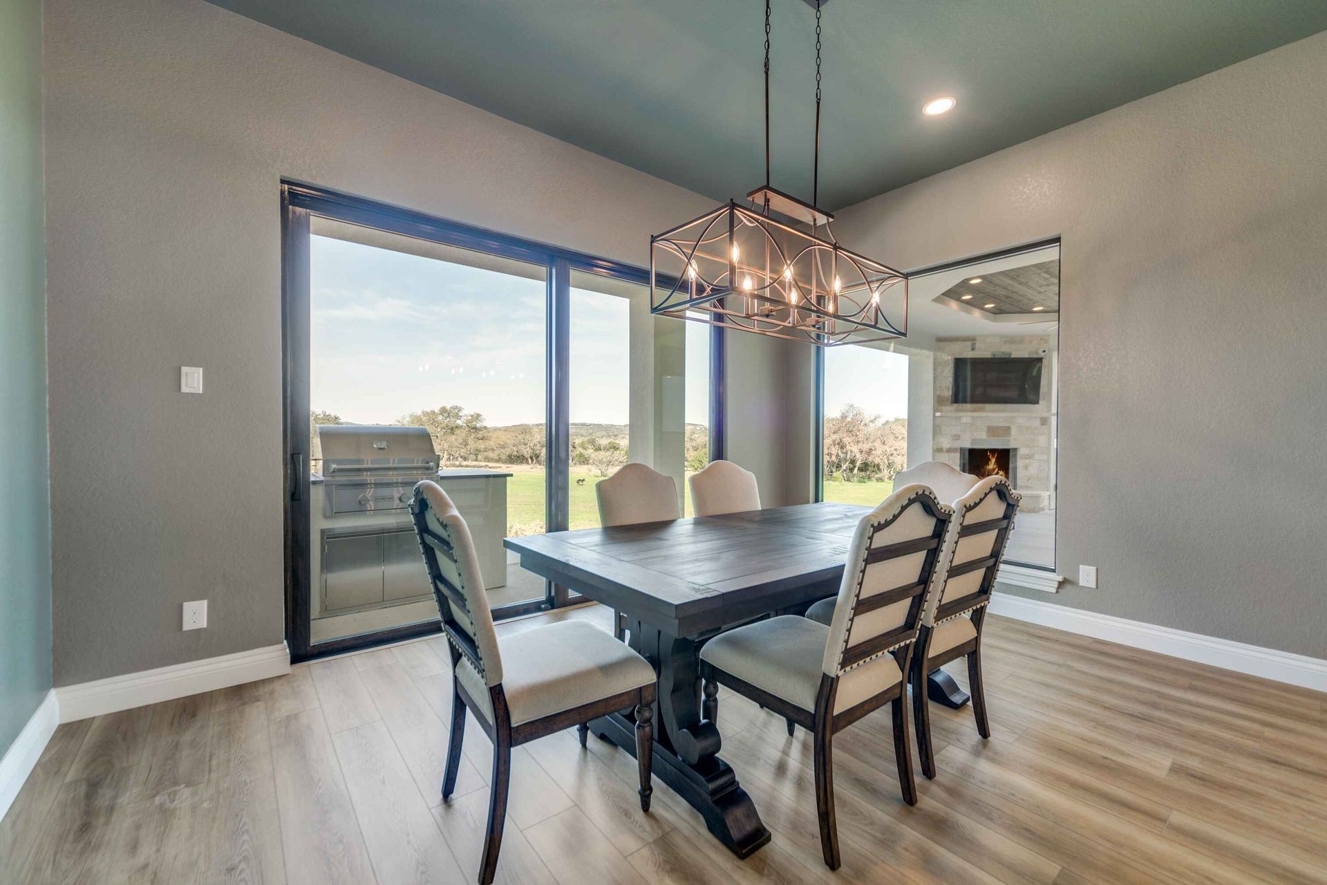 A dining room with a table and chairs and a chandelier.
