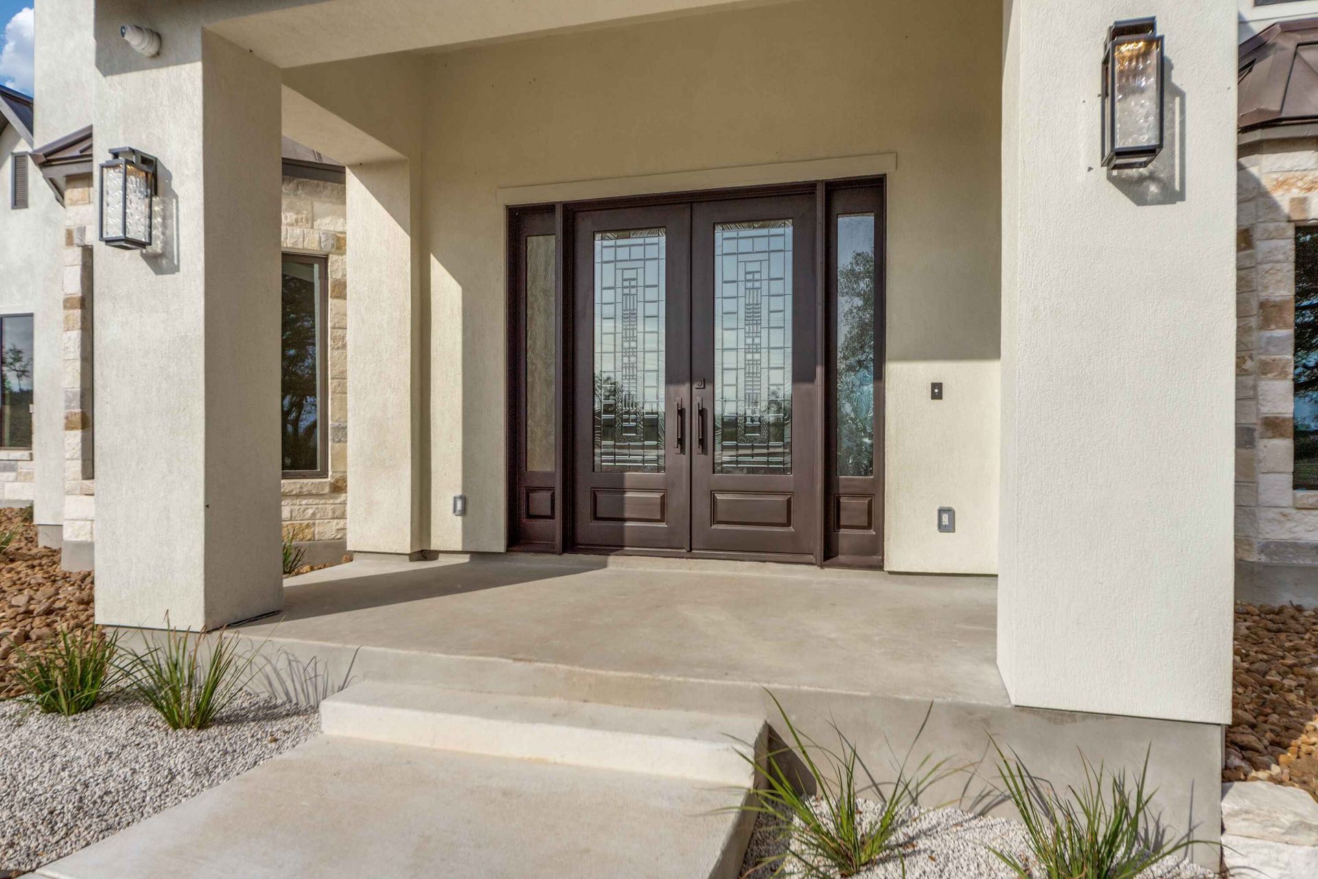 The front door of a house with a concrete walkway leading to it.