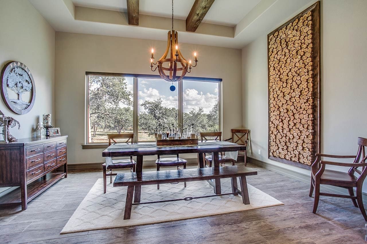 A dining room with a table and chairs and a chandelier.