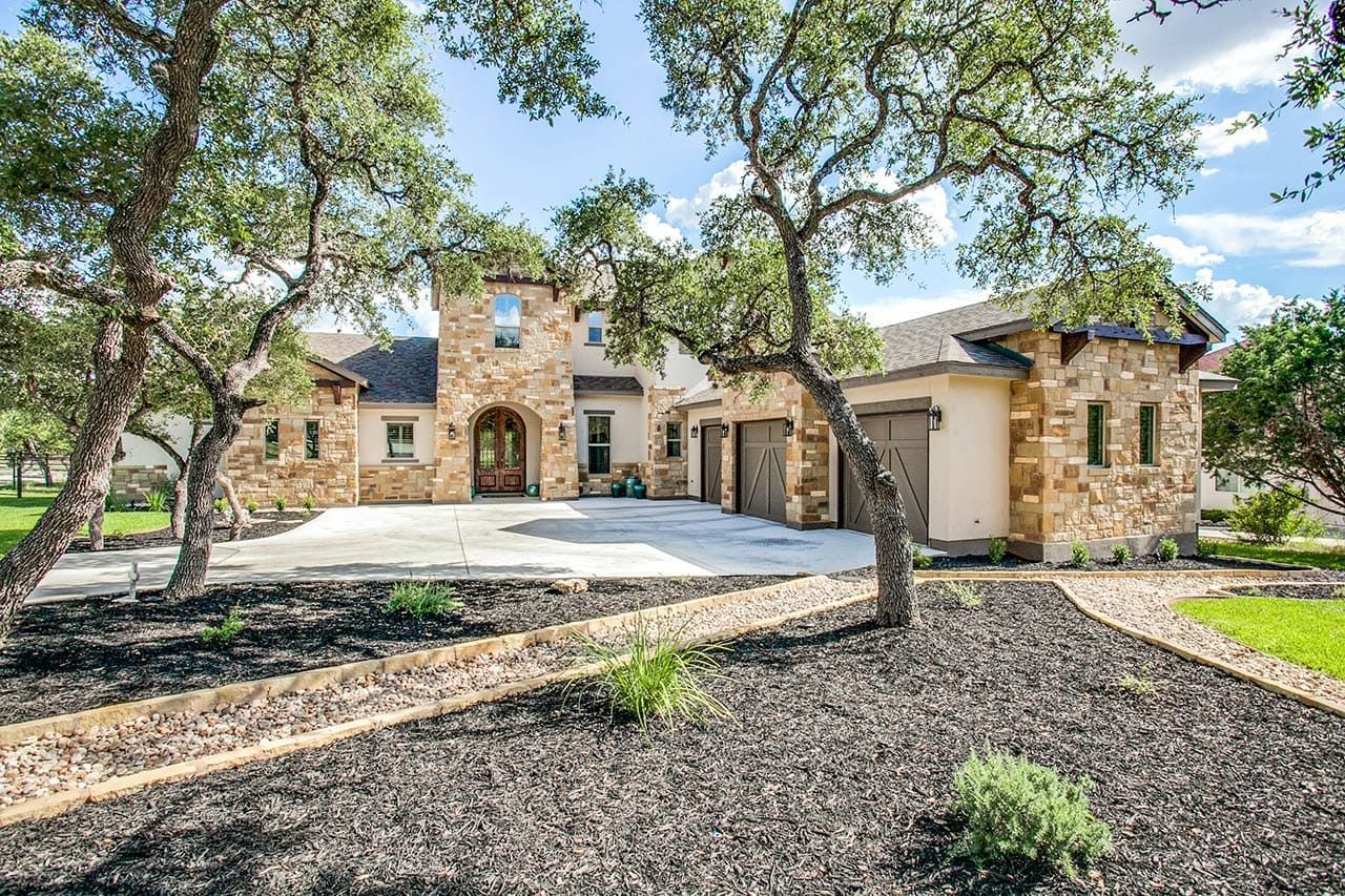 A large house with a lot of trees in front of it.
