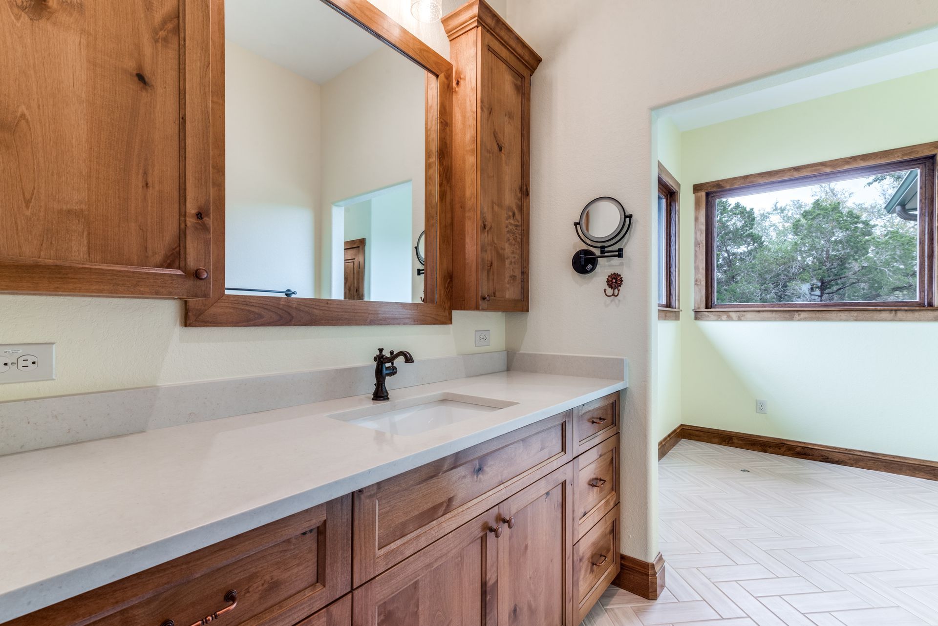A bathroom with two sinks and a large mirror.