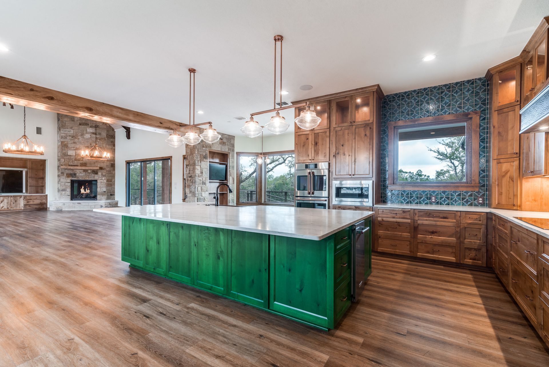 A kitchen with a large green island in the middle of it.