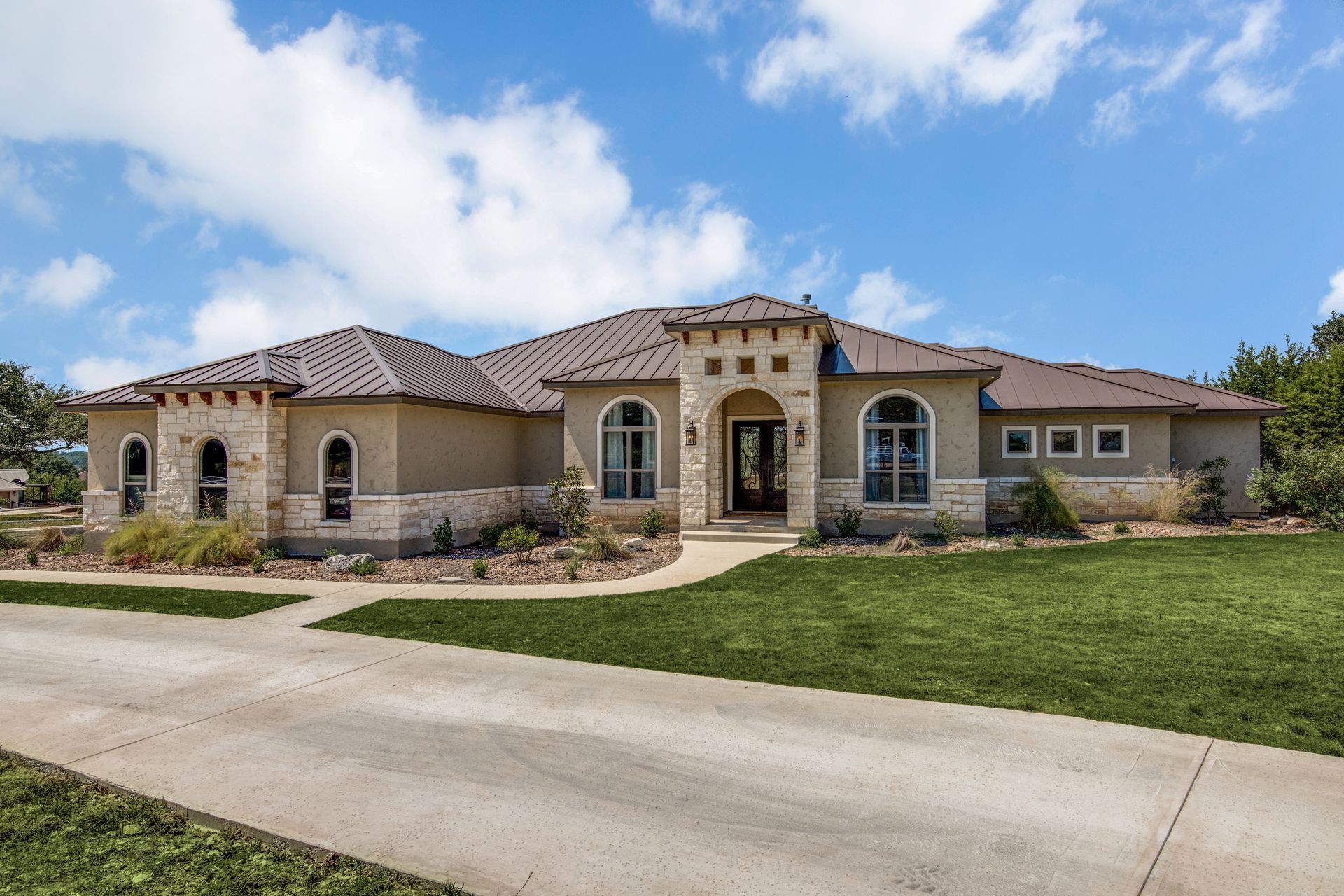 A large house with a concrete driveway leading to it