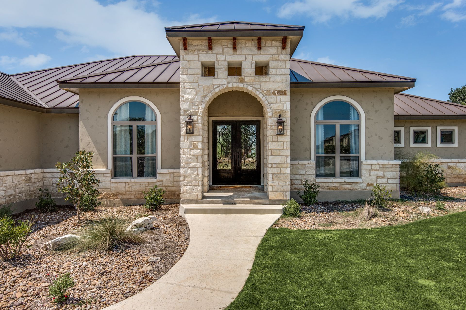 A large house with a walkway leading to the front door