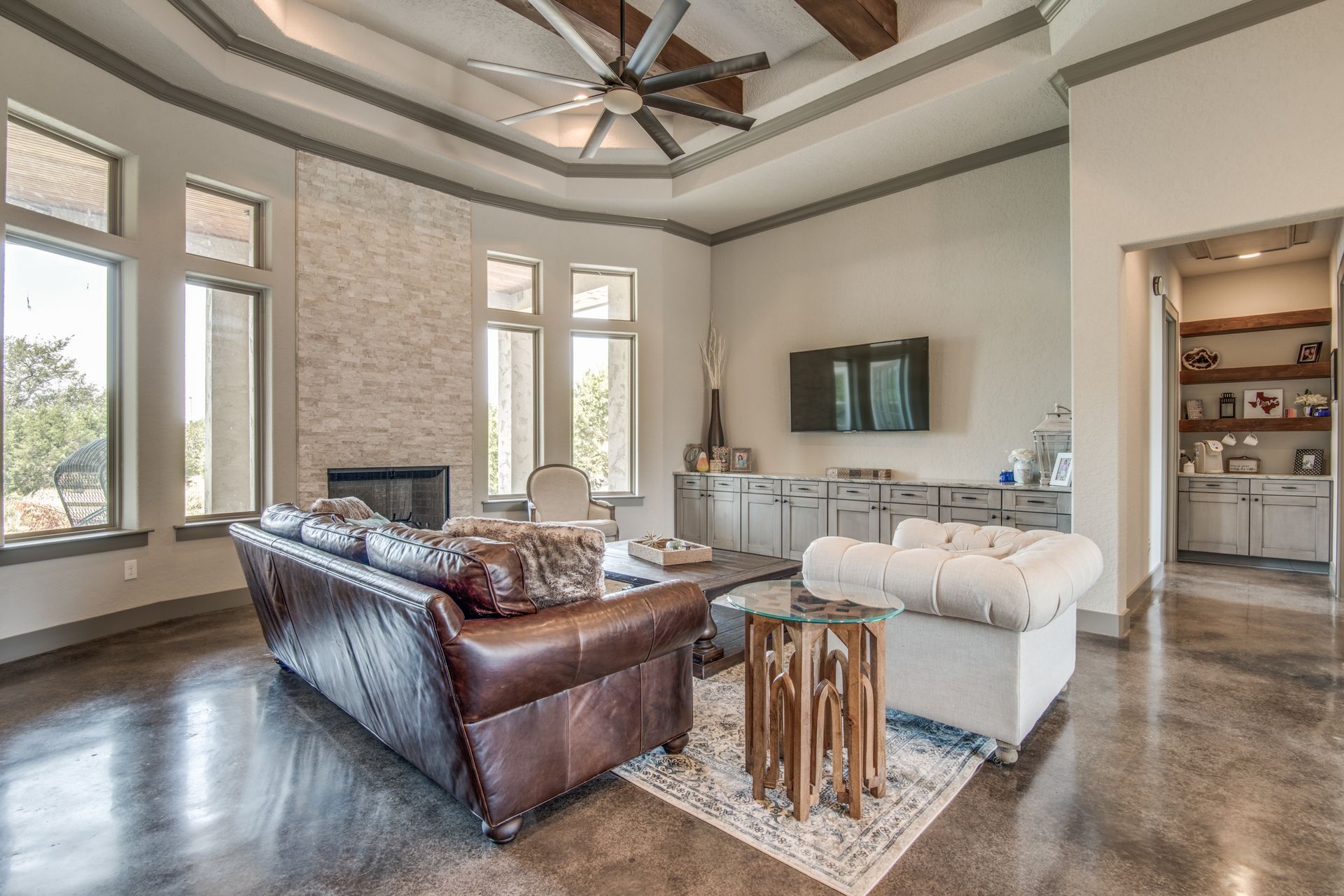 A living room with a couch , chairs , a fireplace and a television.