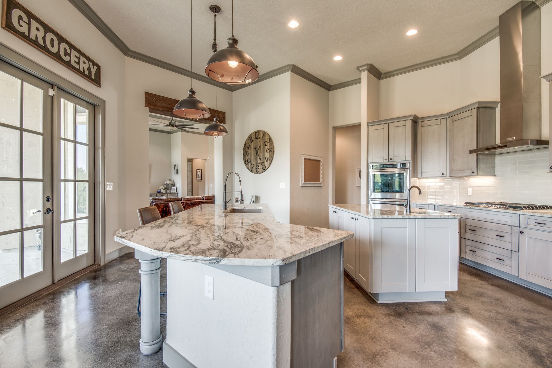 A kitchen with a large island and a sign that says grocery.