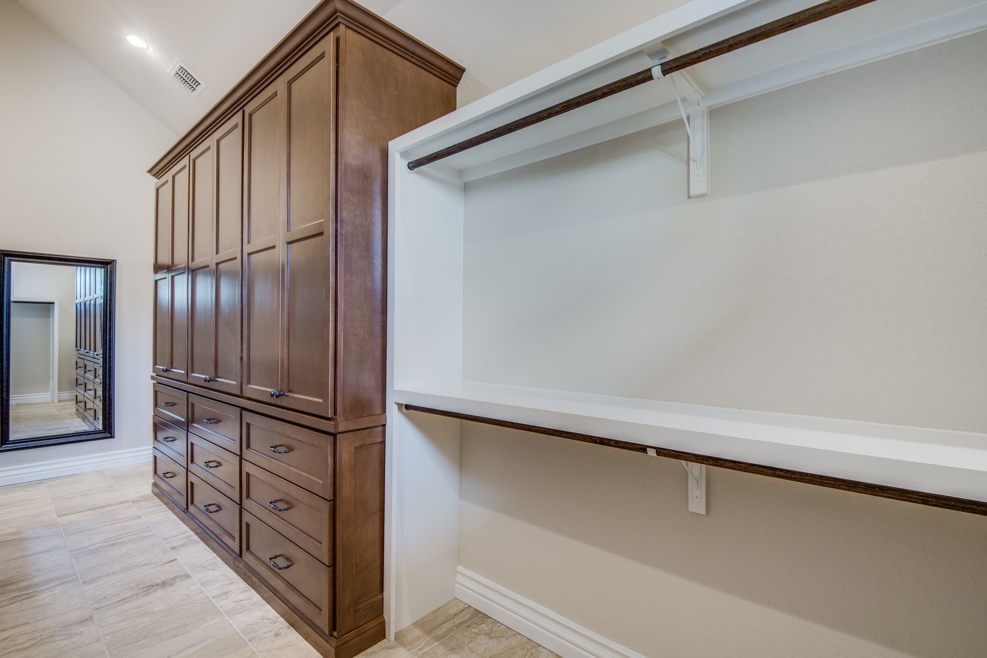 A walk in closet with lots of drawers and shelves.