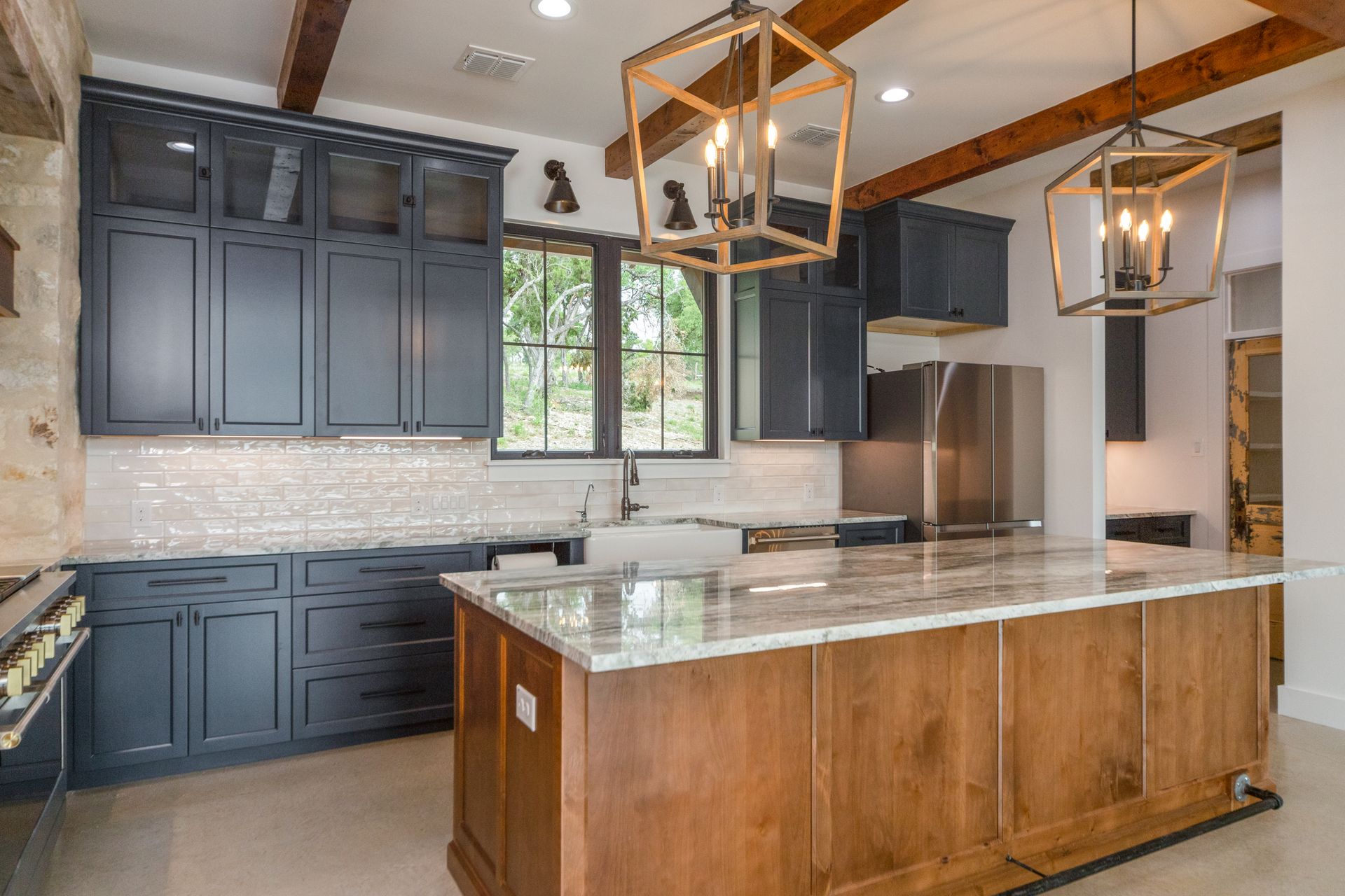 A kitchen with a large island and stainless steel appliances.
