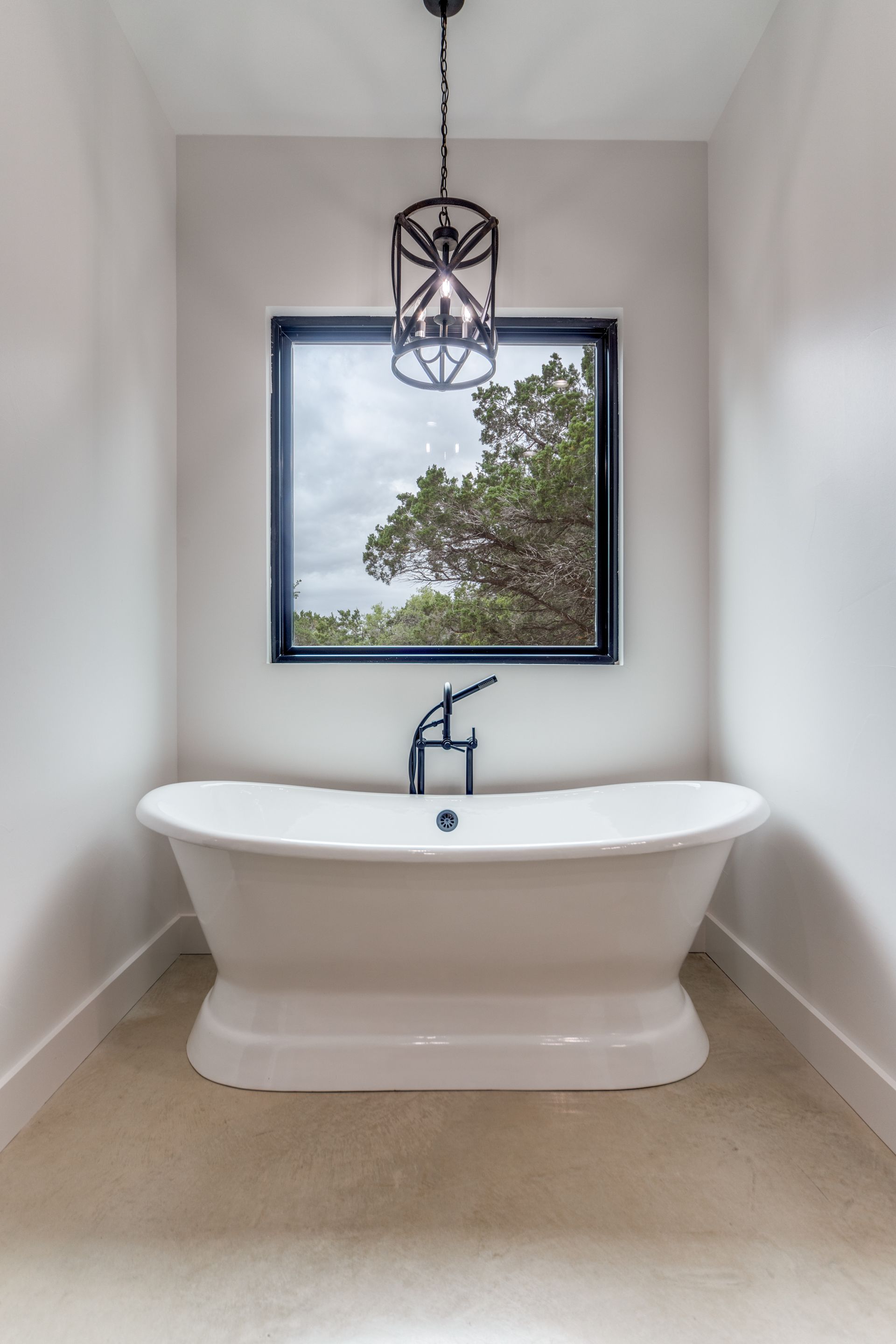 A bathroom with a bathtub and a window.