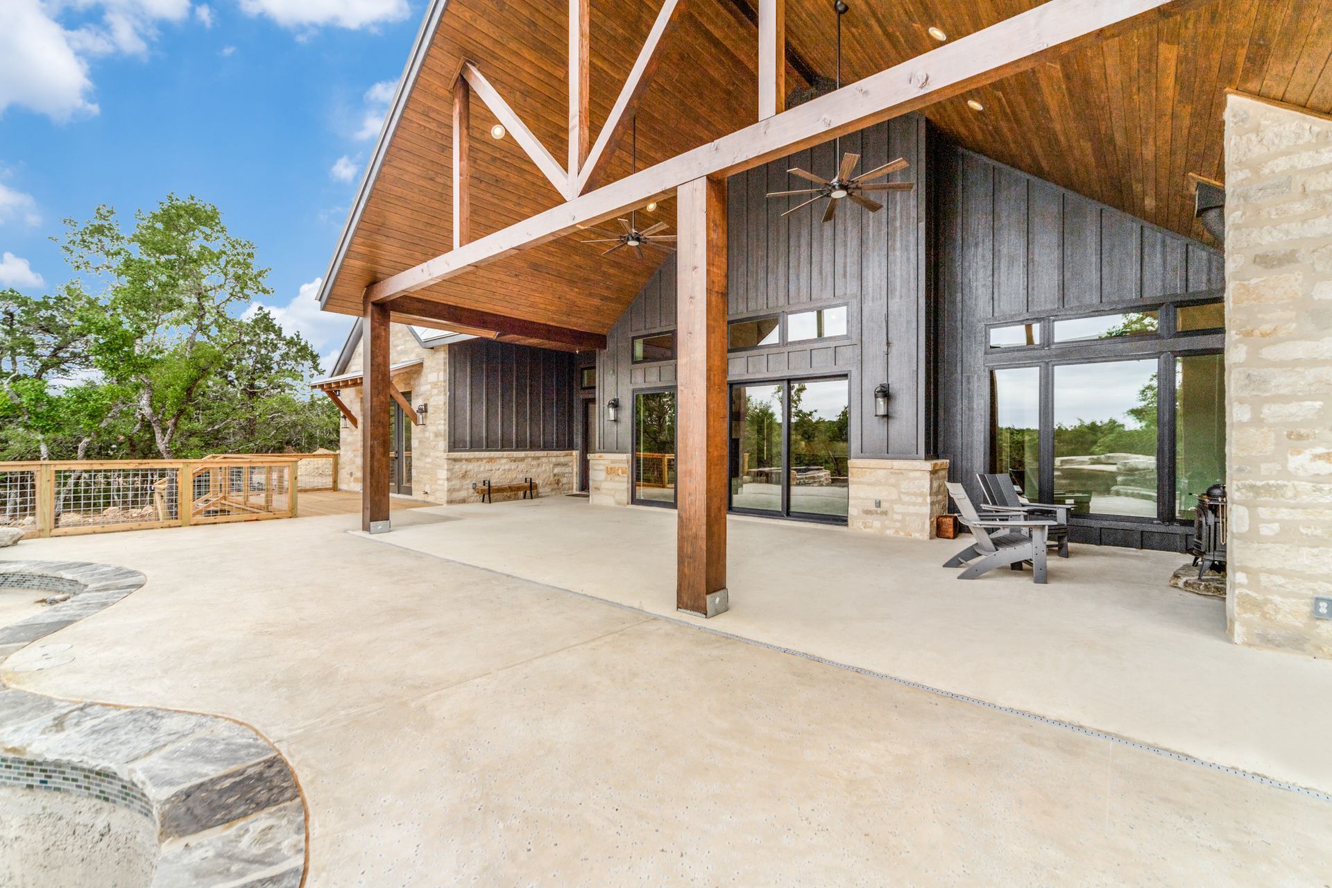 A large house with a covered patio and a ceiling fan.