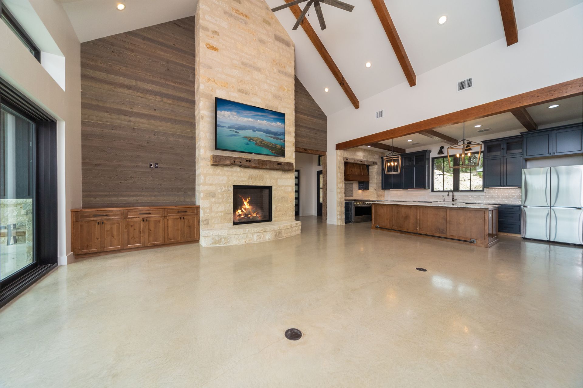 A living room with a fireplace and a flat screen tv.