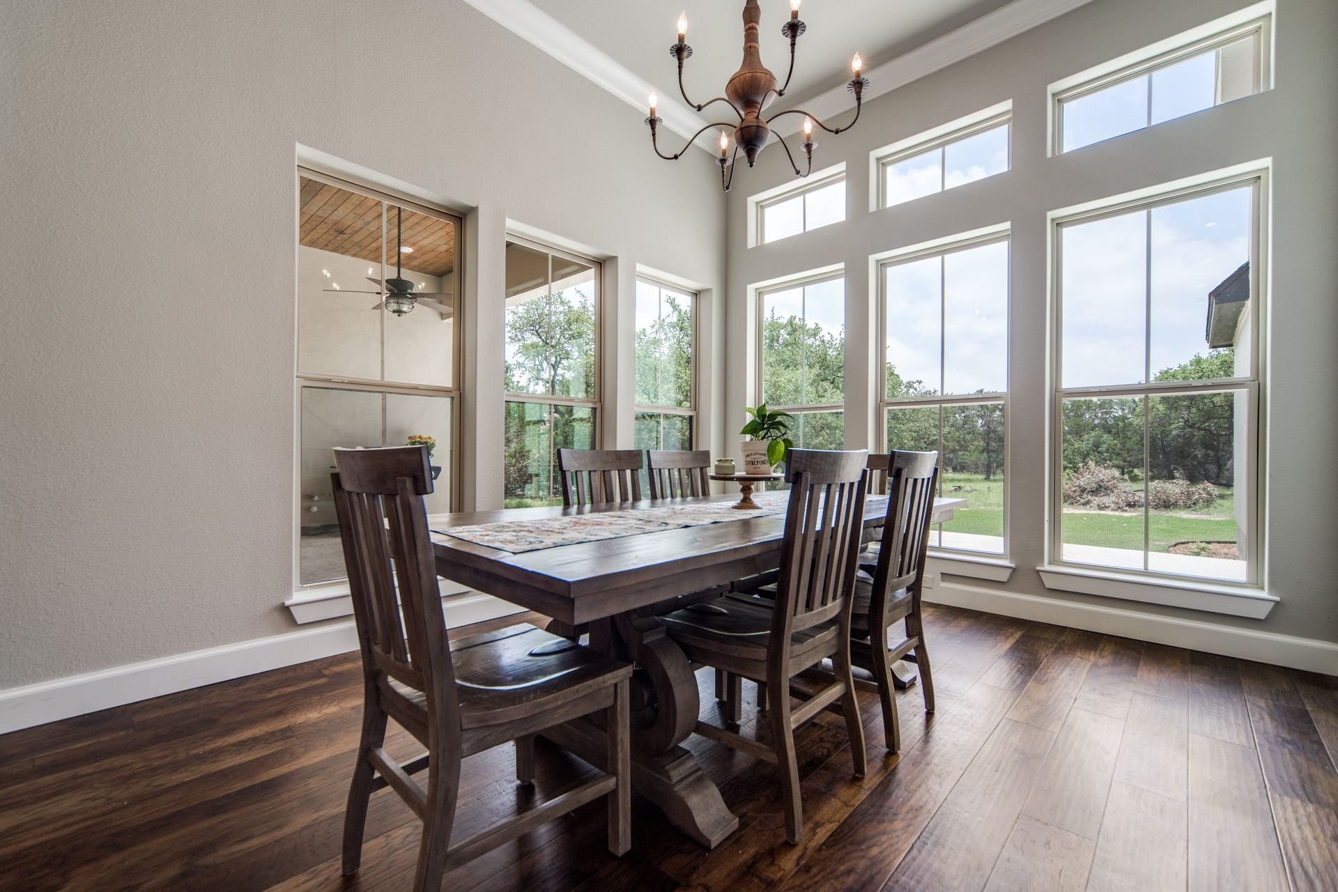 A dining room with a table and chairs and a chandelier.