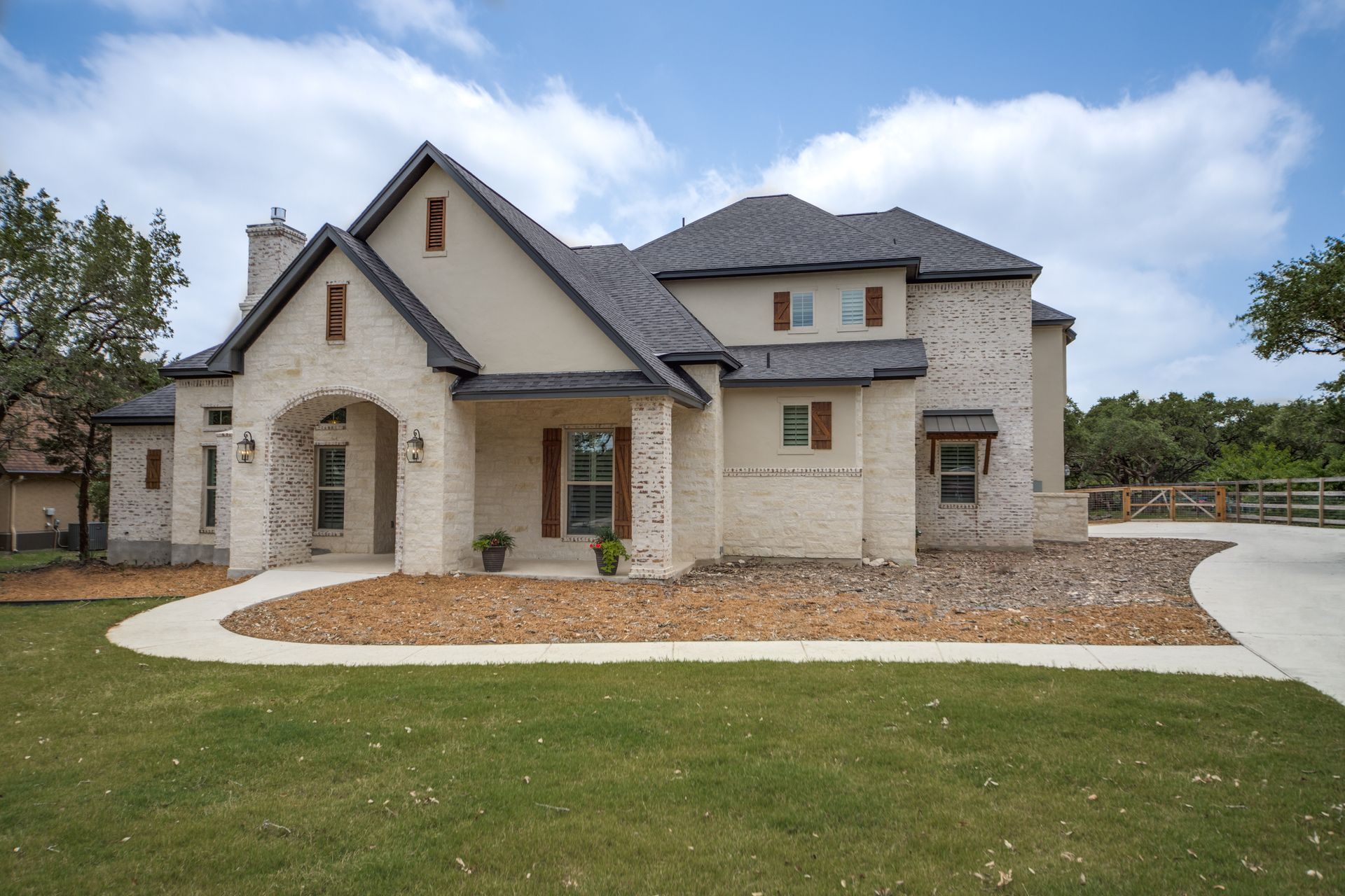 A large white brick house with a gray roof