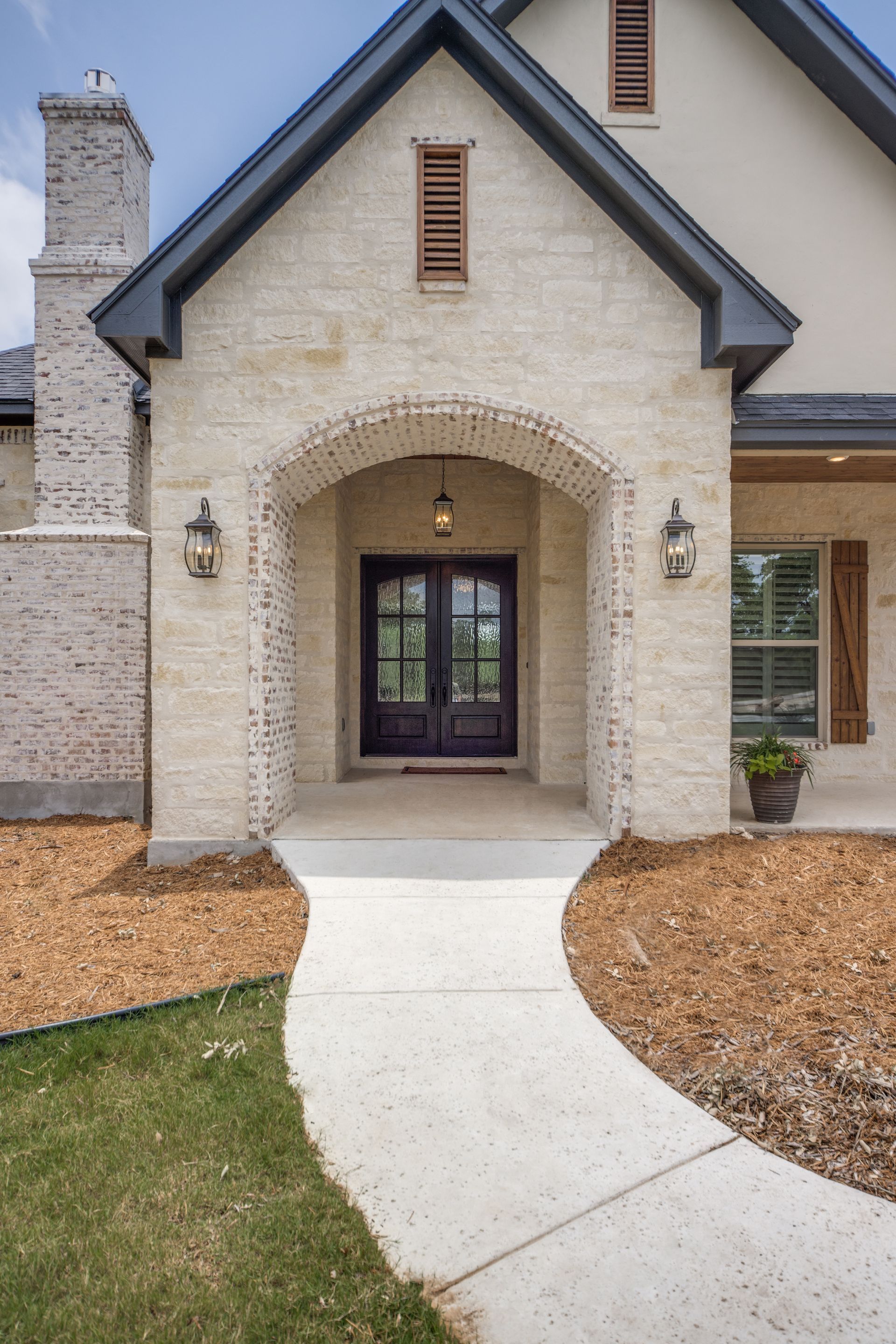 A house with a walkway leading to the front door