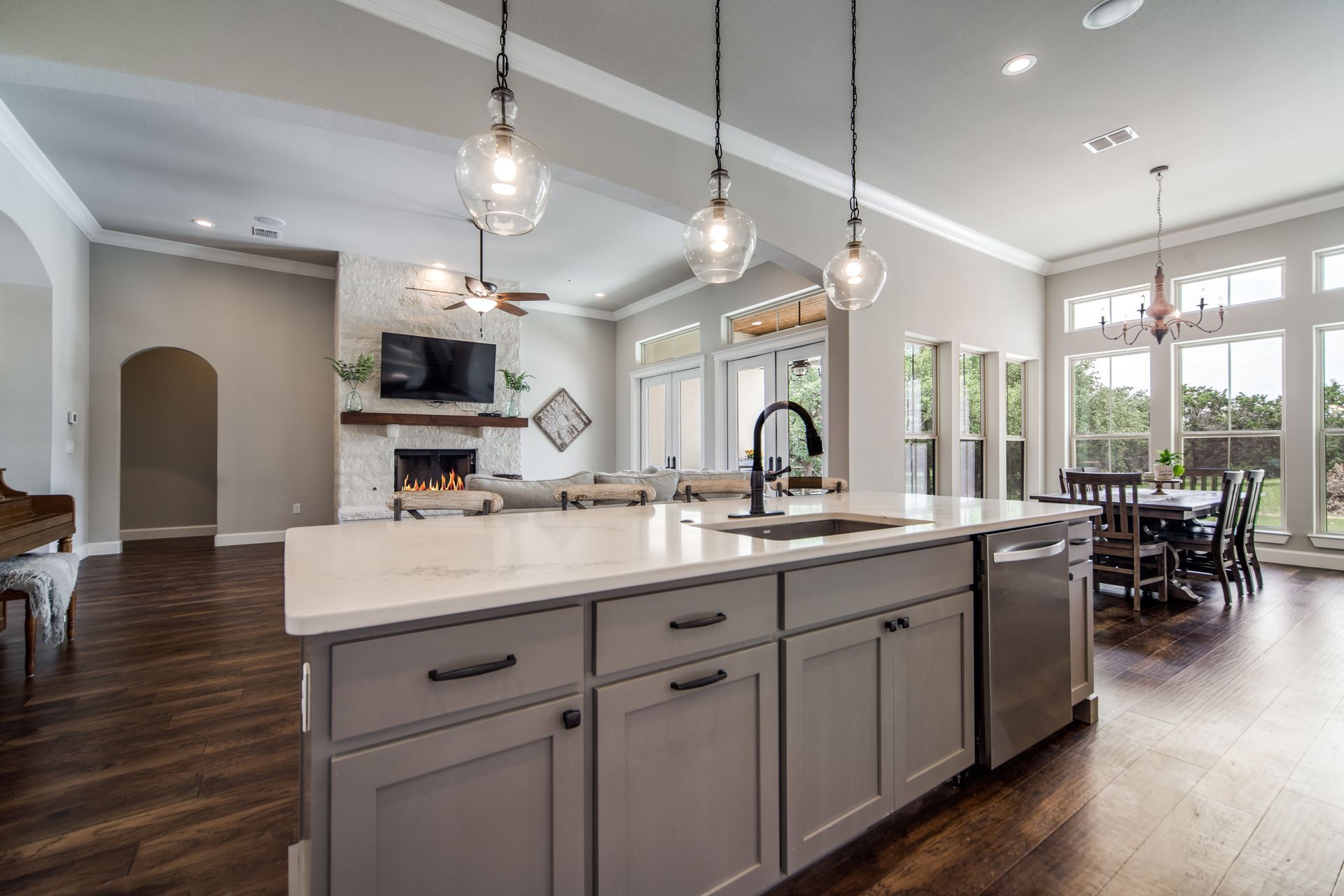 A kitchen in a house with a large island and a sink.
