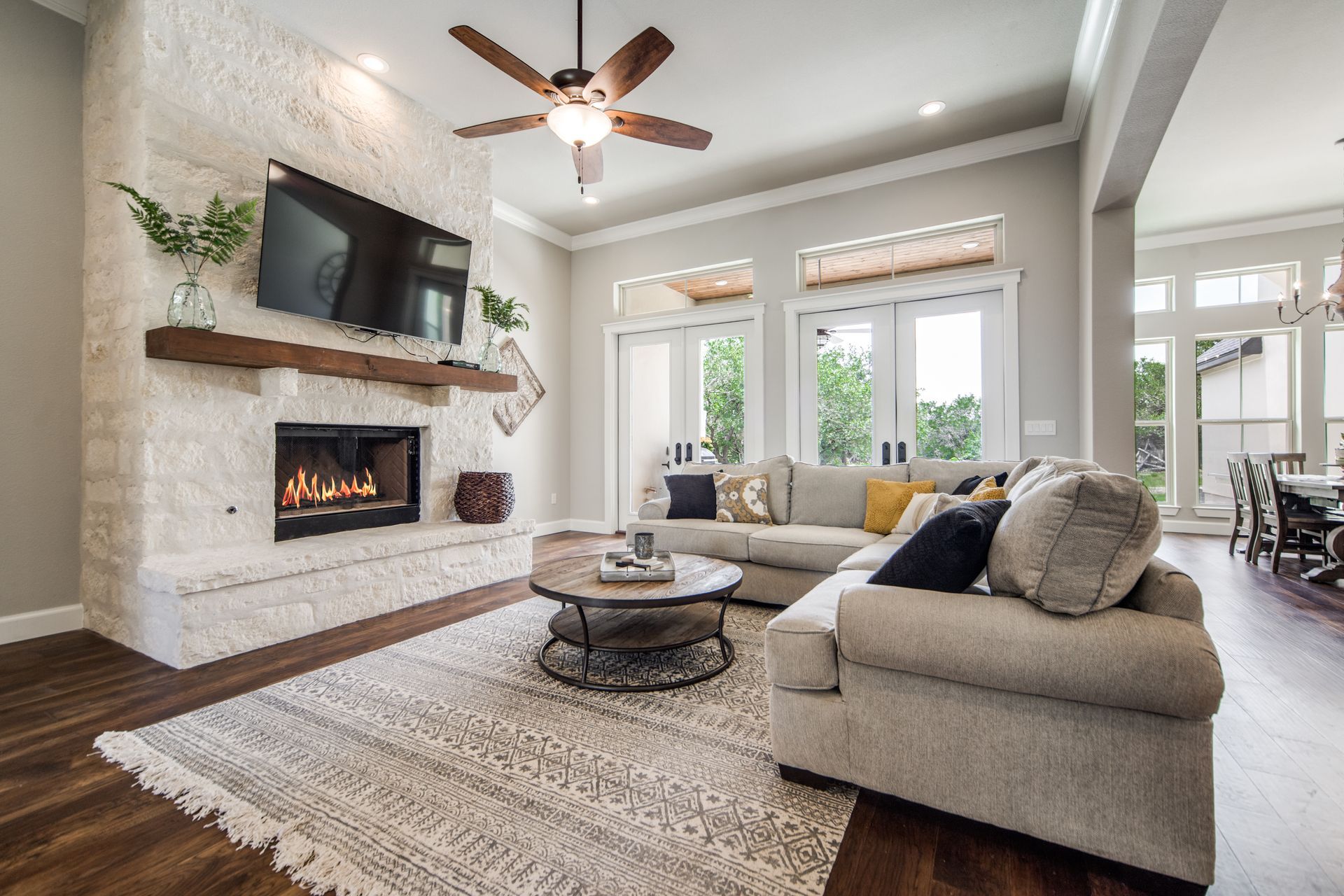 A living room with a fireplace , couch , coffee table and television.