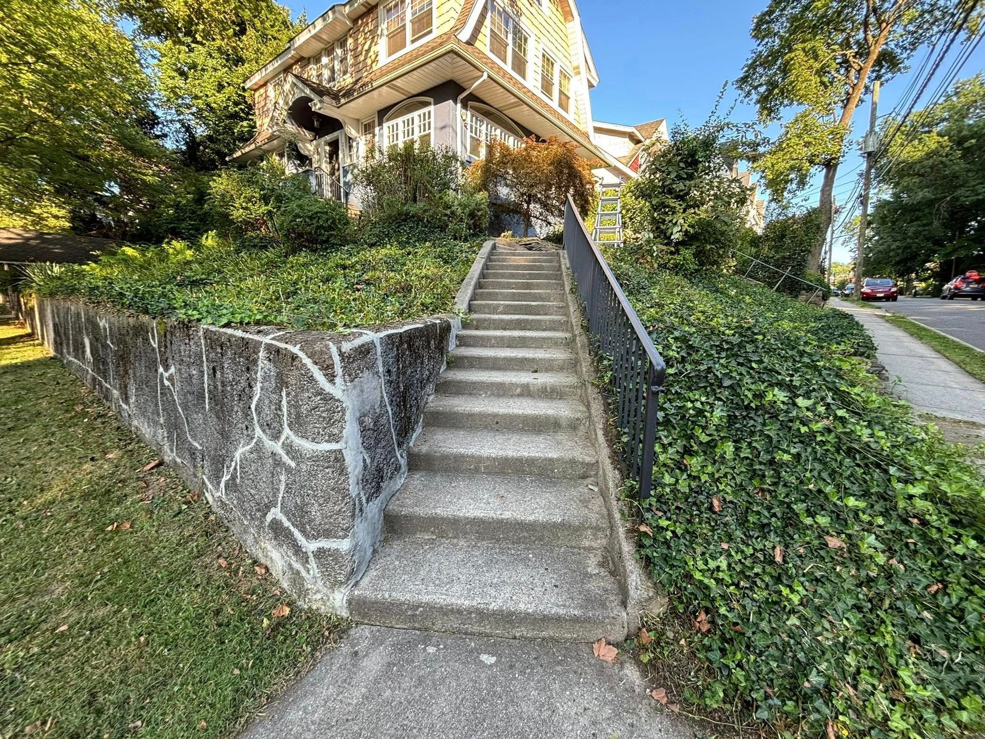 A set of stairs leading up to a house on a hill.