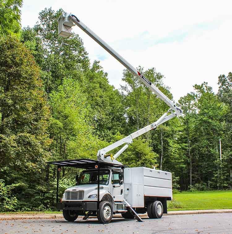 A white truck with a crane on top of it