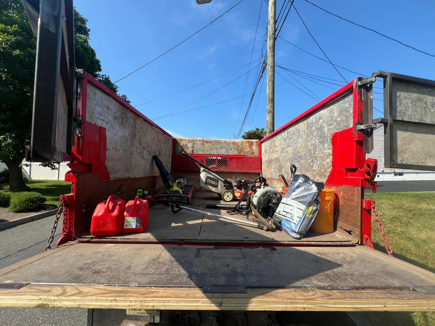 The back of a dump truck with a gas can in the back.