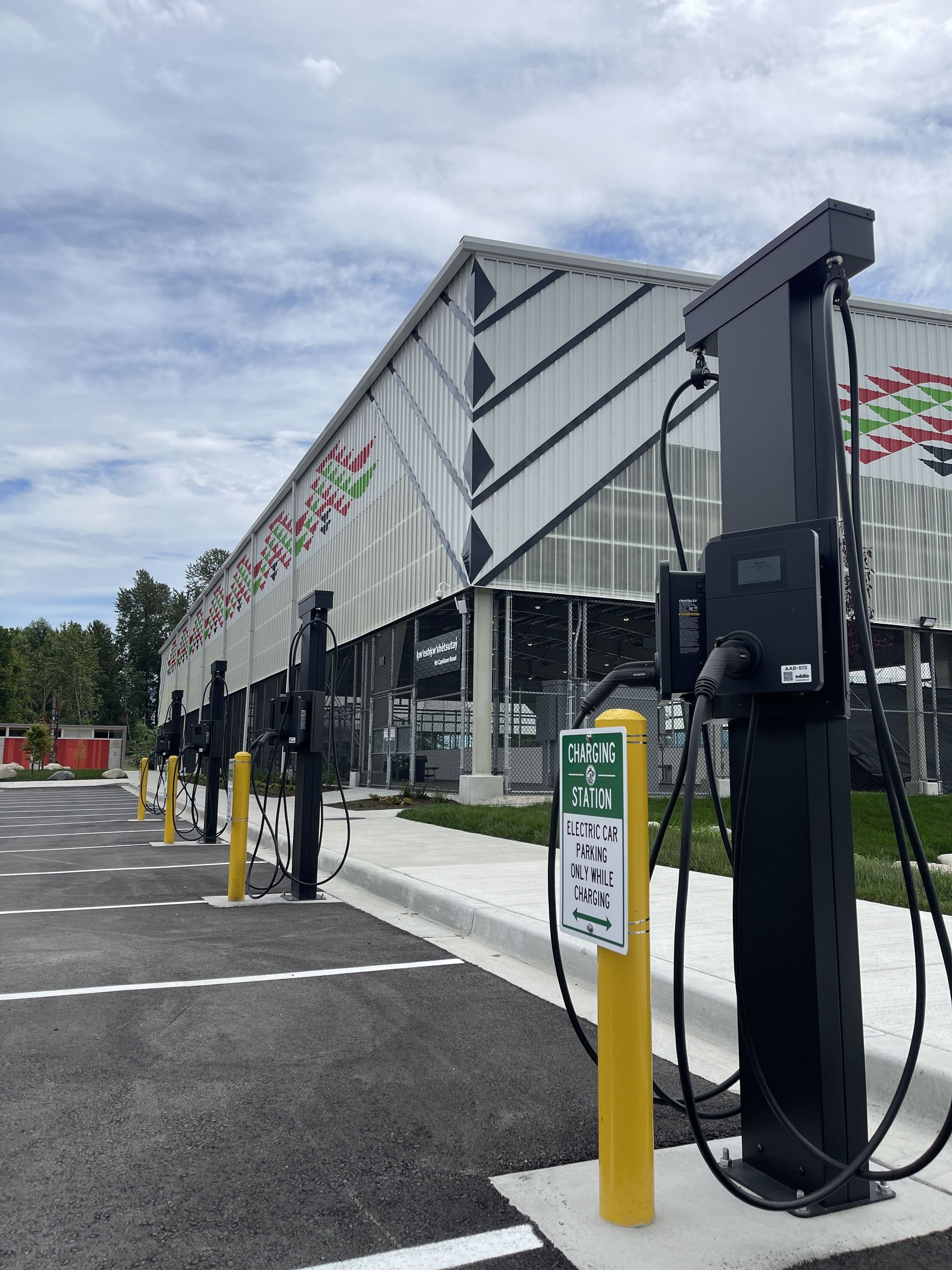 Three Standard Wattz Up EV Charging Pedestals hold two EV chargers each in public parking.