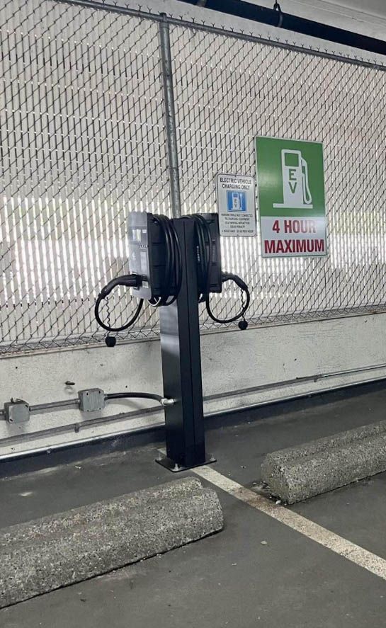 The Standard Wattz Up EV Charging Pedestal holds two EV chargers in public parking.