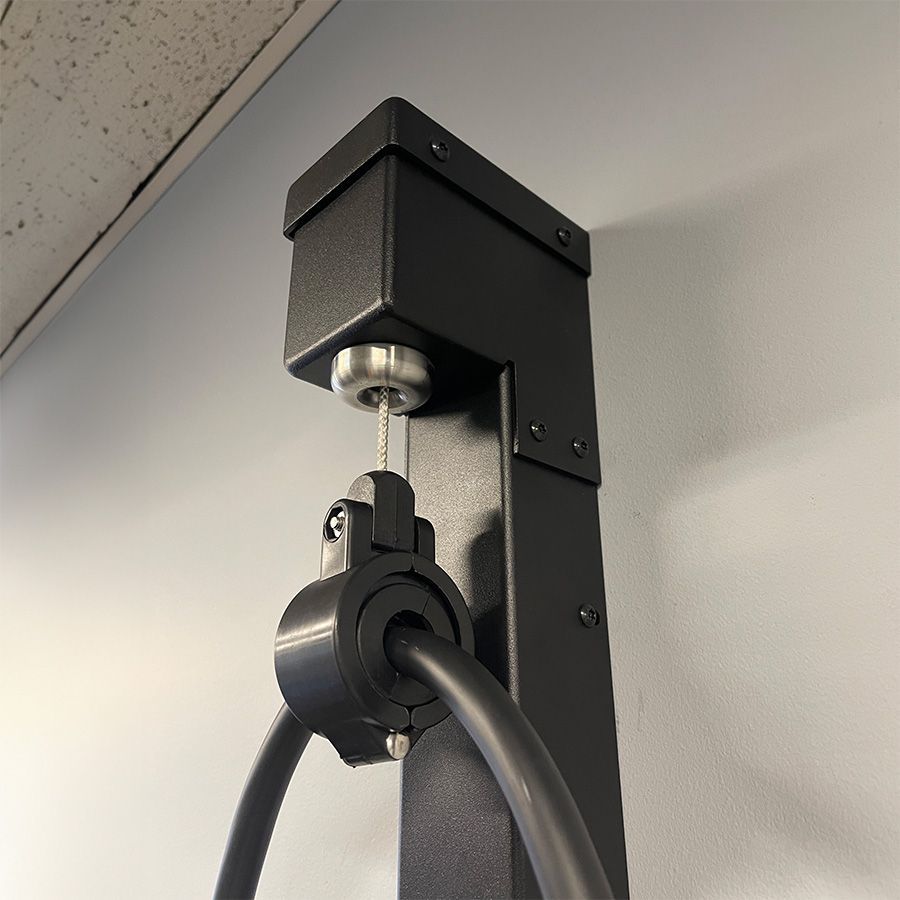 Close up of the retraction pulley from the Wall Retraction Unit by Wattz Up EV Charger Mounting Solutions.