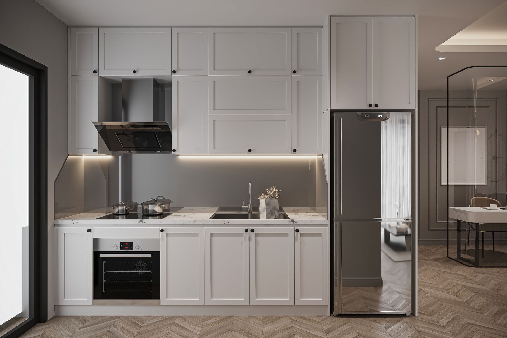 Modern white kitchen with stainless steel appliances and dark trim.