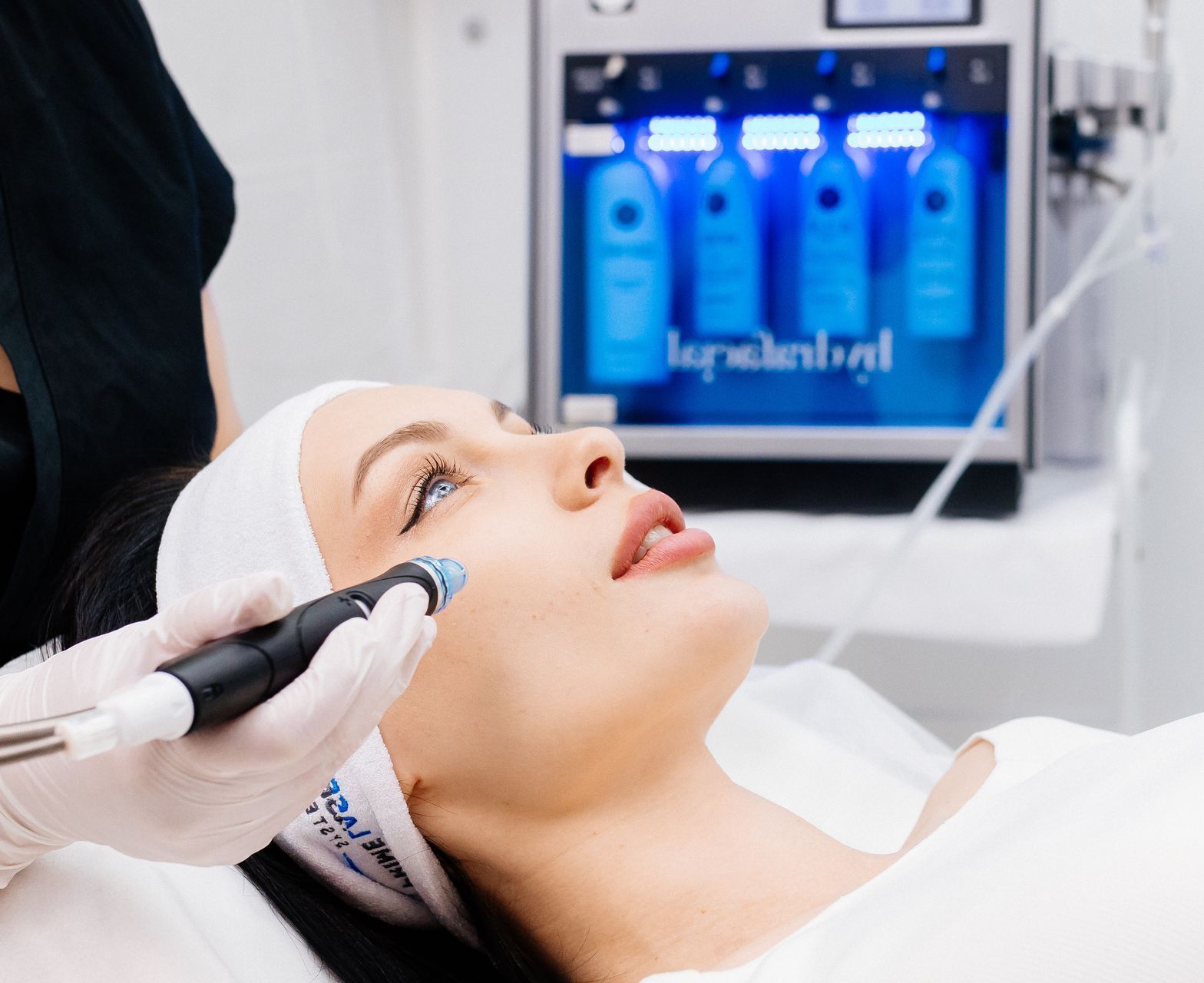 A woman is getting a facial treatment in a beauty salon.
