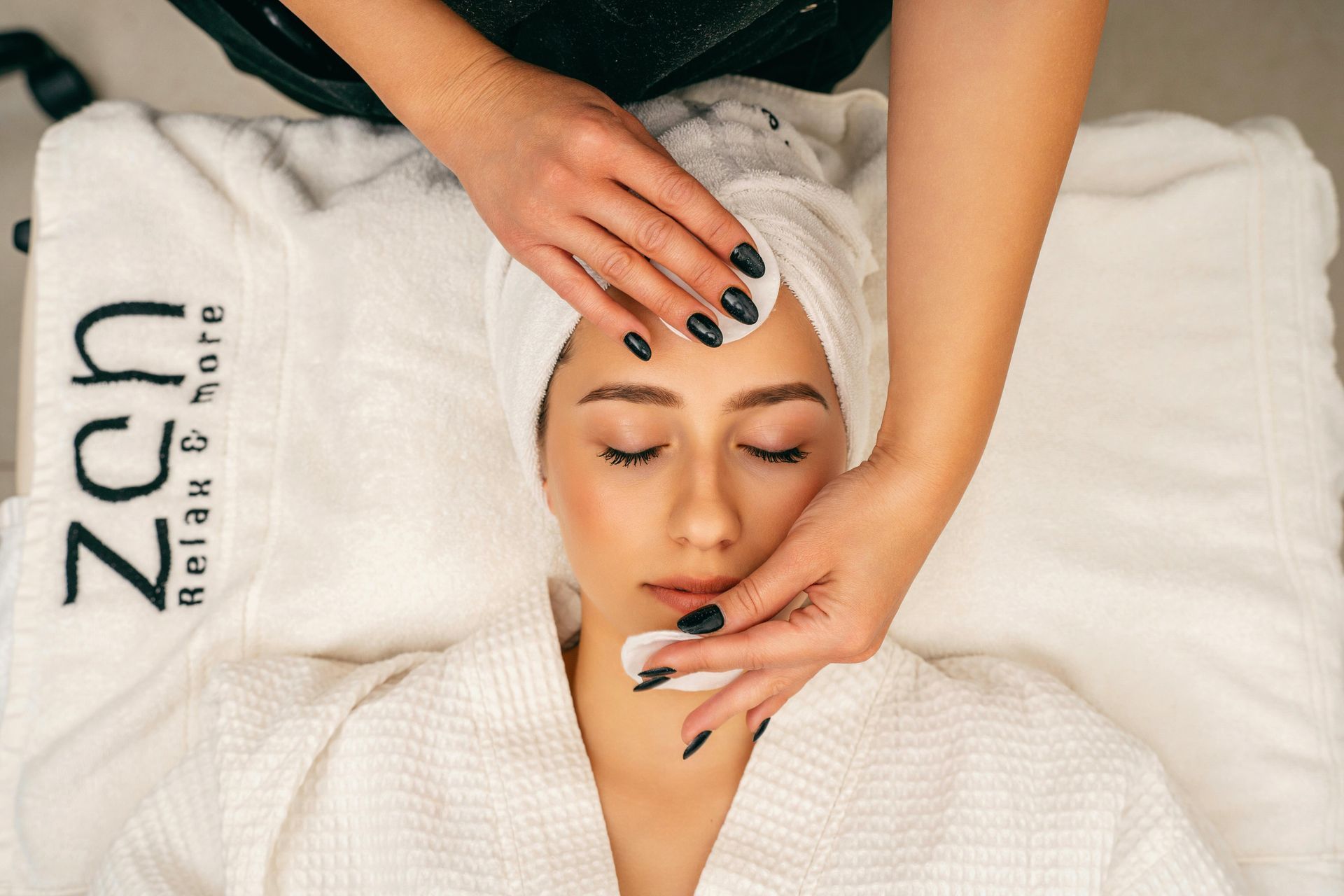 A woman is getting a facial treatment at a spa.