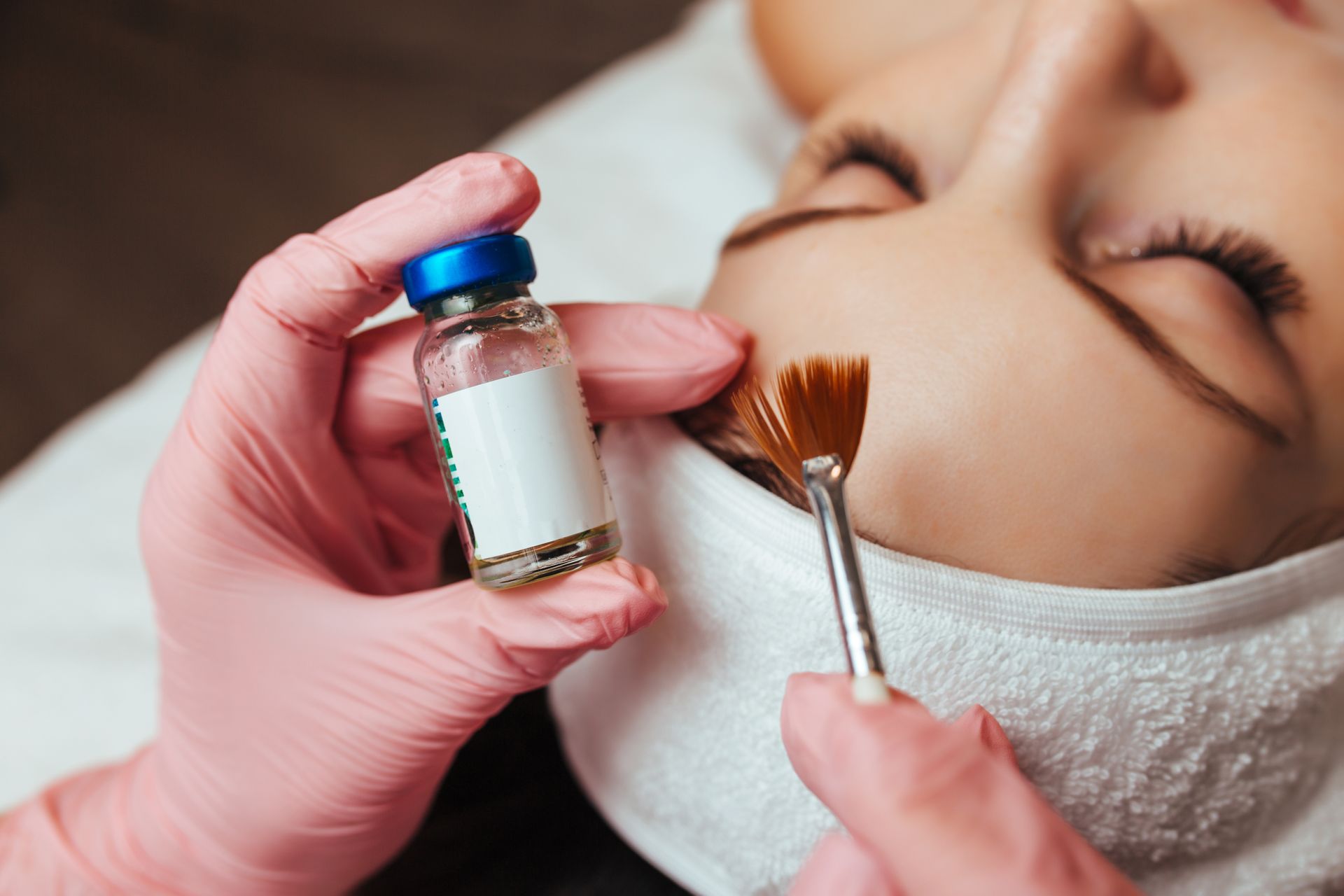 A woman is getting a facial treatment at a beauty salon.