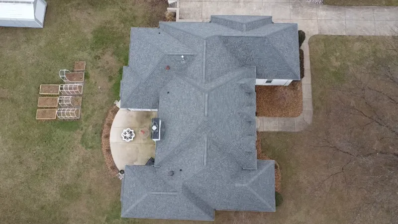 An aerial view of a house with a gray roof.