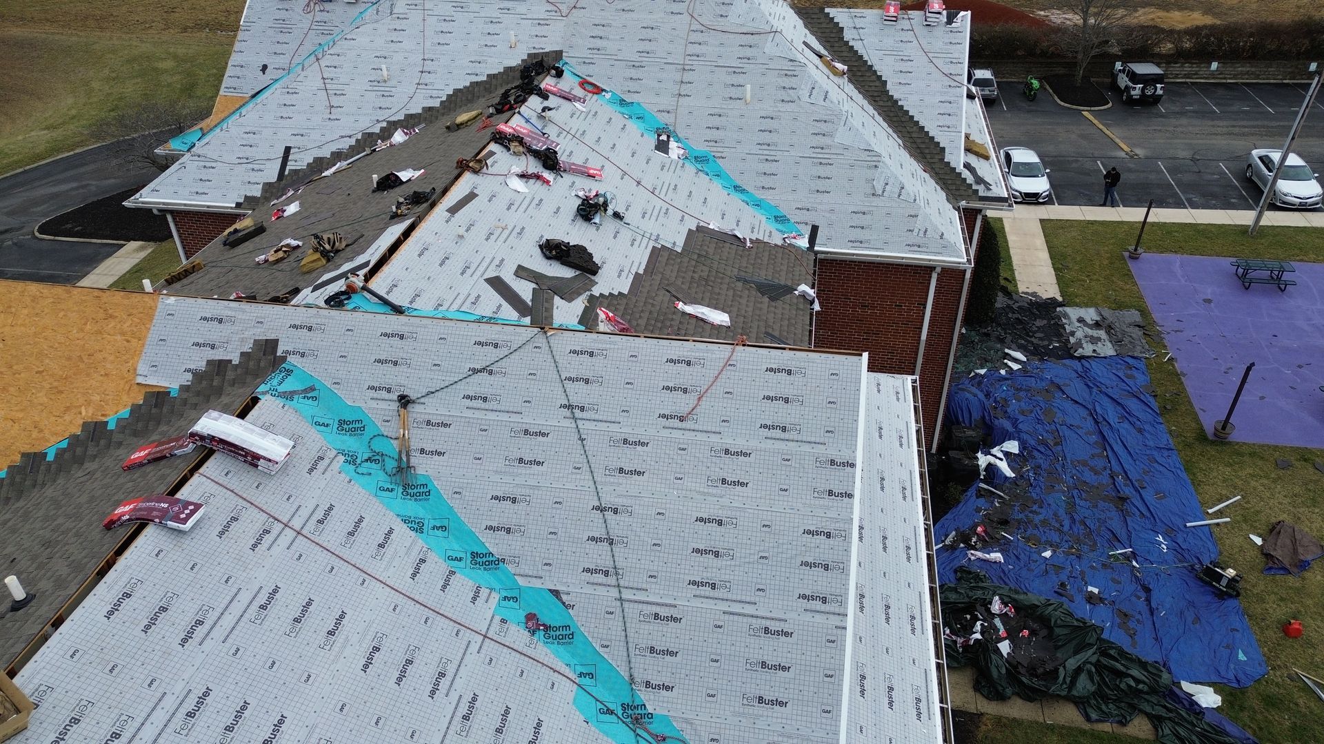 An aerial view of a roof being installed on a building.